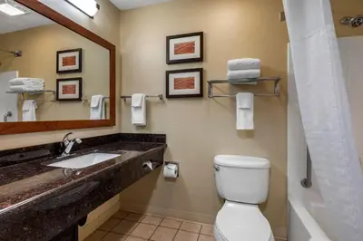a bathroom with a sink and a toilet and a mirror at Comfort Inn & Suites Murrieta Temecula Wine Country in Murrieta
