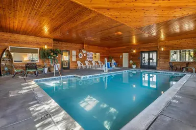 a swimming pool in a house with a wooden ceiling at Comfort Inn & Suites Murrieta Temecula Wine Country in Murrieta
