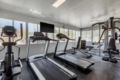 a gym with several tread machines in a room with windows at Comfort Inn & Suites Murrieta Temecula Wine Country in Murrieta