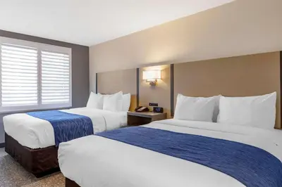 a hotel room with two beds and a window at Comfort Inn San Diego Miramar in Miramar