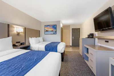 a hotel room with two beds and a flat screen tv at Comfort Inn San Diego Miramar in Miramar