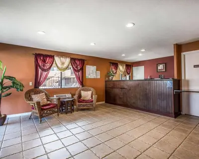 a large room with a waiting area with chairs and a table at Rodeway Inn Santee San Diego East in Santee