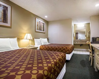 a hotel room with two beds and a kitchen at Rodeway Inn Santee San Diego East in Santee