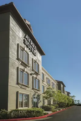 a building with a sign on the side of it at Ayres Suites Mission Viejo - Lake Forest in Mission Viejo