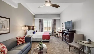 a hotel room with a bed and a television at Ayres Suites Mission Viejo - Lake Forest in Mission Viejo