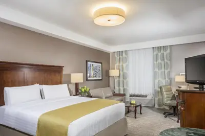 a hotel room with a bed and a flat screen tv at Ayres Hotel Laguna Woods - Aliso Viejo in Laguna Woods
