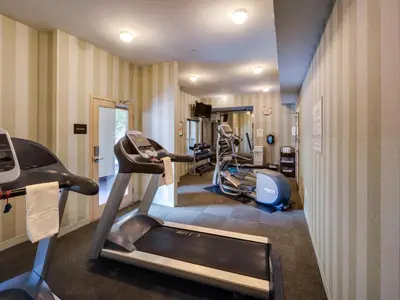 a gym with treadmills and ellipticals in a room at Ayres Hotel & Spa Mission Viejo - Lake Forest in Mission Viejo