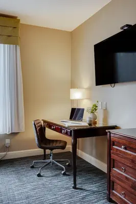 a hotel room with a desk and a laptop on it at Ayres Hotel & Spa Mission Viejo - Lake Forest in Mission Viejo