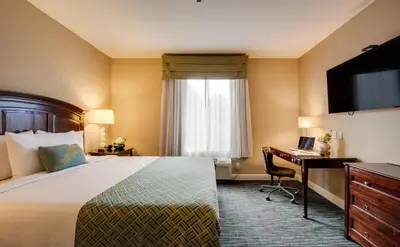a hotel room with a bed and a desk at Ayres Hotel & Spa Mission Viejo - Lake Forest in Mission Viejo