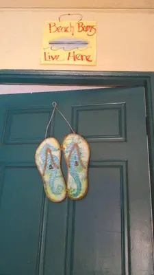 a pair of shoes hanging on a door at 25 Steps to the Beach in Newport Beach
