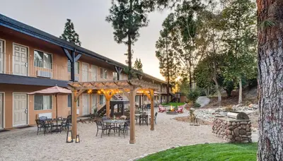 a patio with tables and chairs in front of a building at Ayres Lodge Alpine in Alpine