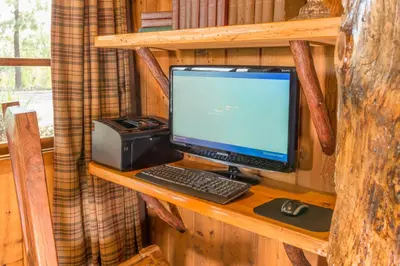 a desktop computer sitting on a wooden shelf in a cabin at Ayres Lodge Alpine in Alpine