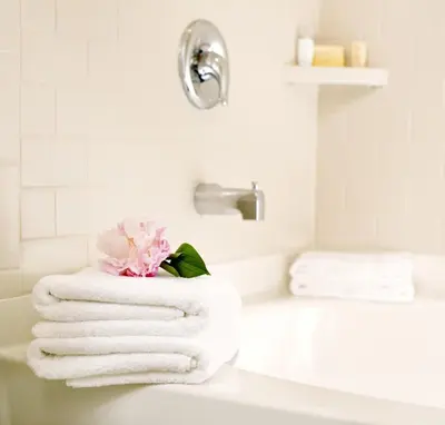 a white bathroom with towels on a sink at Ayres Lodge Alpine in Alpine