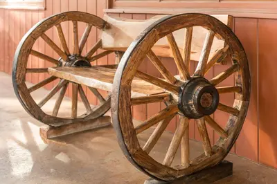 a wooden wagon wheel on display in a museum at Ayres Lodge Alpine in Alpine