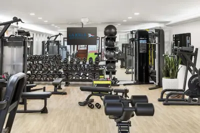 a gym with lots of treadmills and weights at La Jolla Beach & Tennis Club in San Diego