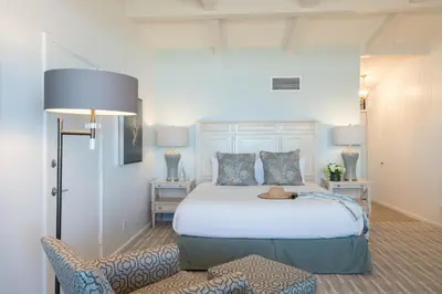 a bedroom with a bed with a hat on it at La Jolla Shores Hotel in San Diego