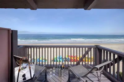 a balcony with a table and chairs and the beach at La Jolla Shores Hotel in San Diego