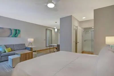 a bedroom with a large bed and a couch at Homewood Suites By Hilton Chula Vista Eastlake in Chula Vista