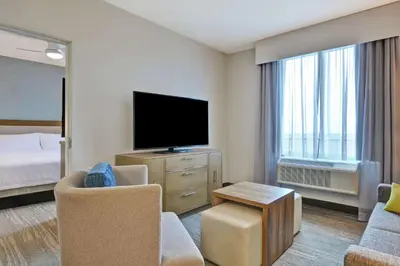 a hotel room with a television and a bed at Homewood Suites By Hilton Chula Vista Eastlake in Chula Vista