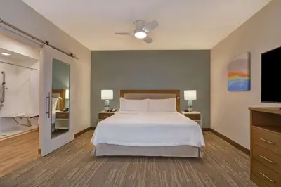 a bedroom with a bed and a flat screen tv at Homewood Suites By Hilton Chula Vista Eastlake in Chula Vista