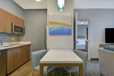 a kitchen with a table and chairs in a room at Homewood Suites By Hilton Chula Vista Eastlake in Chula Vista