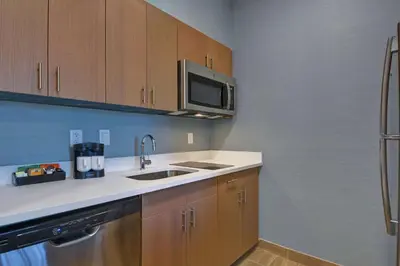 a kitchen with a sink and a microwave at Homewood Suites By Hilton Chula Vista Eastlake in Chula Vista