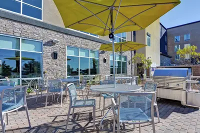 a patio with a table and chairs and an umbrella at Hampton Inn Chula Vista Eastlake in Chula Vista