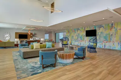 a lobby with a couch and chairs and a tv at Hampton Inn Chula Vista Eastlake in Chula Vista
