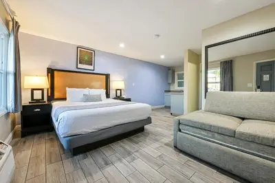 a hotel room with a bed and a couch at Hotel Point Loma in San Diego