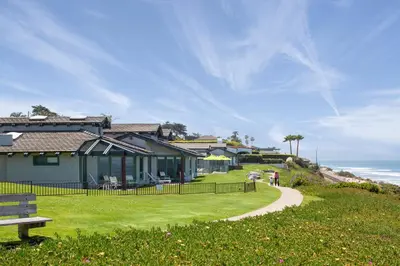 a house on a hill next to a sidewalk at WCH at Wave Crest Resort in Del Mar