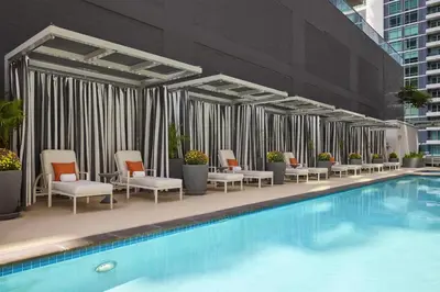 a hotel swimming pool with chairs at Carte Hotel San Diego Downtown, Curio Collection By Hilton in San Diego