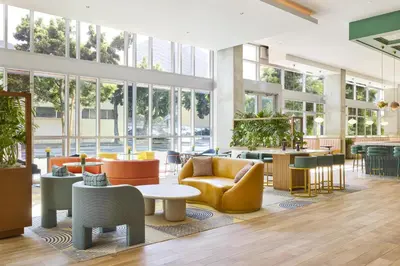 a lobby with chairs and tables and windows at Carte Hotel San Diego Downtown, Curio Collection By Hilton in San Diego