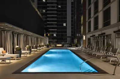 a pool in the middle of a building at night at Carte Hotel San Diego Downtown, Curio Collection By Hilton in San Diego