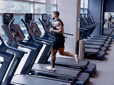 a man running on a treadmill in a gym at Carte Hotel San Diego Downtown, Curio Collection By Hilton in San Diego