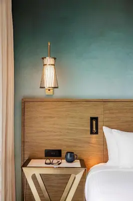 a bedroom with a bed and a table with a lamp at Carte Hotel San Diego Downtown, Curio Collection By Hilton in San Diego