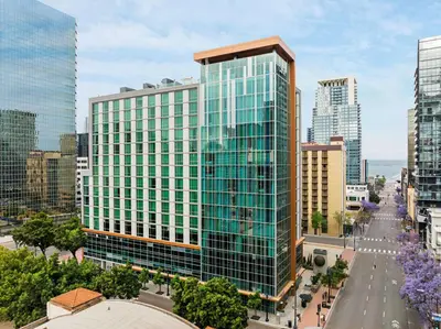 a rendering of a tall glass building in a city at Carte Hotel San Diego Downtown, Curio Collection By Hilton in San Diego