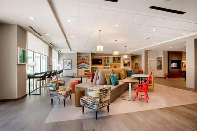 a living room with a couch and a table at Home2 Suites By Hilton Carlsbad, Ca in Carlsbad