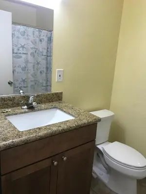 a bathroom with a sink and a toilet at Hacienda Motel in Escondido