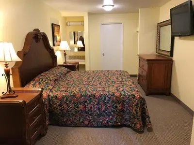 a hotel room with a bed and a television at Hacienda Motel in Escondido