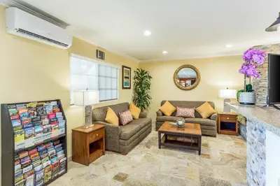 a living room with a couch and a fireplace at Quality Inn Escondido San Diego North County in Escondido