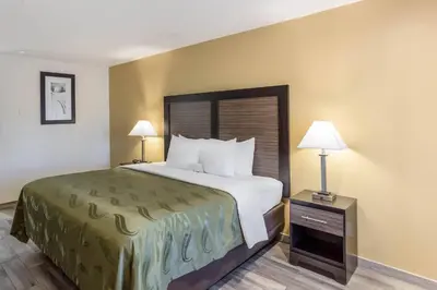 a hotel room with a bed and two lamps at Quality Inn Escondido San Diego North County in Escondido