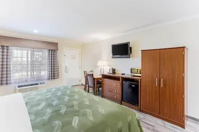 a hotel room with a bed and a kitchen at Quality Inn Escondido San Diego North County in Escondido