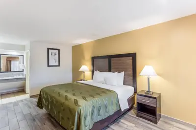 a hotel room with a bed and two lamps at Quality Inn Escondido San Diego North County in Escondido