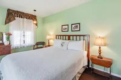 a bedroom with a white bed and a window at Julian Lodge in Julian