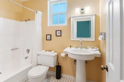 a bathroom with a white toilet and a sink at Julian Lodge in Julian