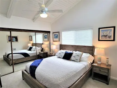 a bedroom with two beds and a ceiling fan at Luv Oceanside Views-1 House to Beach, Boardwalk and Waves-Spacious Rooftop Sun Deck-Plus King Beds too! in San Diego