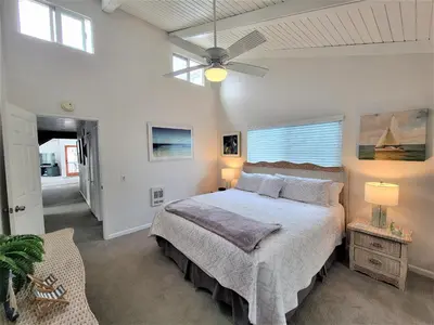 a bedroom with a bed and a ceiling fan at Luv Oceanside Views-1 House to Beach, Boardwalk and Waves-Spacious Rooftop Sun Deck-Plus King Beds too! in San Diego