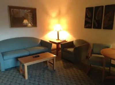 a hotel room with a couch and chairs and a table at Borrego Springs Resort in Borrego Springs