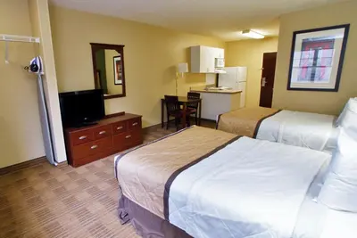 a hotel room with two beds and a flat screen tv at Extended Stay America Suites - San Diego - Oceanside in Oceanside
