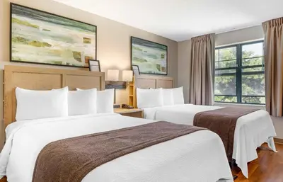 a hotel room with two beds and a window at Extended Stay America Suites - San Diego - Carlsbad Village by the Sea in Carlsbad